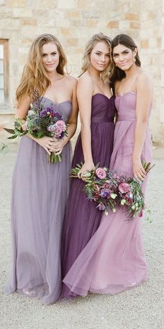 three bridesmaids in strapless purple dresses