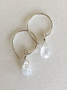 "Genuine Rainbow moonstone briolette earrings on handmade Sterling silver ear wires. Luxe AAA faceted petite 9-10 mm pear briolettes are wire wrapped in Sterling on lovely petite handmade Sterling silver curled ear hooks. Total drop length is 1 3/8\". Lots of sparkle! Moonstone is said to be a stone of \"new beginnings\" with a calming energy. It enhances intuition and promotes success and good fortune in love and business matters." Dainty Faceted Sterling Silver Earrings, Nickel-free Adjustable Briolette Earrings, Delicate Briolette Sterling Silver Earrings, Adjustable Teardrop Moonstone Earrings, Faceted Moonstone Teardrop Earrings, Teardrop Moonstone Faceted Earrings, Briolette Crystal Earrings With Ear Wire For Gift, Gift Crystal Briolette Earrings With Ear Wire, Briolette Crystal Earrings For Gifts