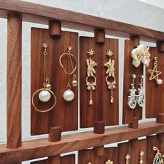 a wooden shelf with earrings on it