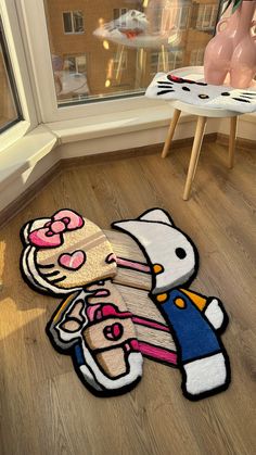 hello kitty rugs on the floor in front of a window