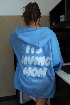 Its Giving Mom Cool Mom Club Carolina Blue Zip Up – where comfort meets style in the trendiest way possible! Its giving mom printed in white ink and cool mom club printed in light blue ink 💚👩‍👧‍👦 #MomClubChic #TrendyMomEssentials Karrie is wearing a size 2XL. Features 8 oz./yd² (US) 13.3 oz./L yd (CA), 50/50 cotton/polyester, 20 singles Classic fit Unlined hood with color-matched drawcord Metal zipper Overlapped fabric across zipper allows full front printing 1 x 1 rib with spandex for enhan Casual Light Blue Hoodie With Letter Print, Trendy Light Blue Cotton Hoodie, Trendy Mom, Cool Mom, Moms Club, Club Parties, Party Shop, Metal Zipper, Carolina Blue