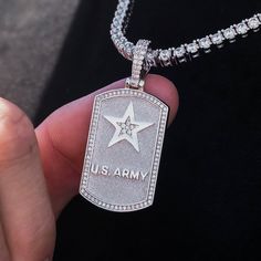 Introducing the U.S. Army Dog Tag Pendant, designed exclusively with the United States Army. Handcrafted in 14k White Gold, this pendant represents the courageous souls who safeguard our nation. The dog tag features the U.S. Army Logo with hand-set stones inside the star and an iced out border ensuring durability and long-lasting shine. Show your support and instill a sense of pride every time you wear this symbol of bravery and resilience. This product is guaranteed for life - GLD will repair t White Gold Dog Tag Jewelry With Polished Finish, Tarnish Resistant Silver Dog Tag Jewelry, Tarnish Resistant Silver Dog Tag, Silver Laser Engraved Dog Tag Jewelry, Silver Tarnish Resistant Jewelry For Commemoration, Silver Tarnish-resistant Jewelry For Commemoration, U S Army Logo, Army Dog Tag, Army Dogs