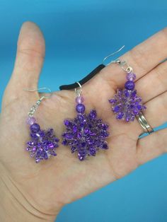 "With its origins tied to royalty and ceremony, purple flowers represent dignity, pride and success. Whether grouped alone in a bold range of rich hues or mixed in with other colors to provide depth and contrast, an arrangement filled with purple blooms represents accomplishment and admiration. These Purple flower earrings dangle at 2\" and are 1\" wide." Flowers Represent, Flower Earrings Dangle, Earrings And Necklace, Resin Earrings, Purple Flower, Earrings Dangle, Flower Earrings, Purple Flowers, Other Colors