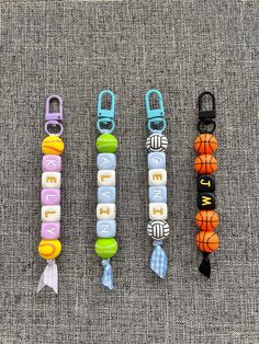 four different types of dog collars and leashes on a gray surface with the word bead spelled out in small letters