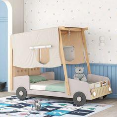 a child's bed with a tent on the top