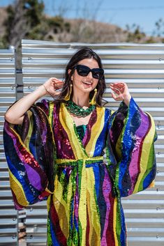 Introducing the beautifully unhinged Jennafer Grace Rainbow Road Kimono. This elegant piece boasts an iridescent sequin design with art nouveau inspiration. A wild addition to any wardrobe, this kimono can be worn as a stunning dress or layered over your favorite outfits. Don't miss out on the limited options for this must-have item. Extra long belt can be enjoyed Obi-style and features extra long fringe at ends. To preserve the luscious sequins, we recommend dry cleaning or hand washing this ga Fitted Kimono For Spring Party, Elegant Spring Party Kimono, Elegant Kimono For Party In Spring, Elegant Kimono For Spring Party, Fitted Evening Kimono For Summer, Spring Party Dress With Kimono Sleeves, Multicolor Summer Party Kimono, Summer Party Multicolor Kimono, Spring Party Multicolor Kimono