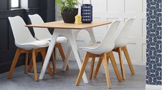 a table with four chairs and a vase on it