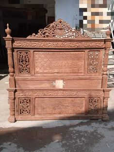 an old wooden bed with intricate carvings on it