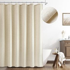 a white shower curtain in a bathroom next to a wooden table and sink with a mirror on the wall