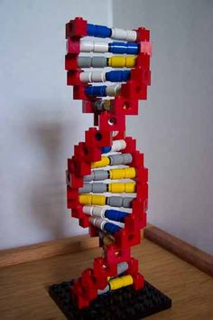 a sculpture made out of legos on top of a wooden table