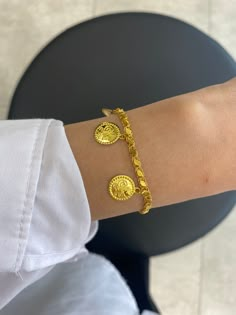 "14K Solid Gold Ottoman Monogram Bracelet / Turkish Embossed  Coin  Bracelet / Ottoman Sign Pressed Disc Bracelet * Gold KT: 14K Solid Gold * Gold Color: Dark Yellow Gold (The colors are exactly the same as in the photo) * Chain Lengths: 6\"-8\" Follow on Instagram - @bayargold.tr My Web Site - https://www.bayargold.com * Bayar Gold is a fine jewelry company. Please do not hesitate to ask us questions. We are always here to help you. * All items are packed in the high-quality jewelry box. The gift message is available. Please let us know what to write by leaving us a note at checkout.  * Gift wrapping available.  Express shipping * United States: 4-6 business days * Canada: 4-6 business days * Europe: 4-6 business days * Australia: 4-6 business days * UK: 4-6 business days * Worldwide: 2-7 Albanian Gold Jewelry, Coin Bracelet Gold, Turkish Gold Jewelry, Gold Coin Bracelet, Turkish Bracelet, Gold Ottoman, Photo Chain, Tiny Heart Necklace, New Gold Jewellery Designs