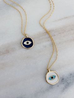 This evil eye necklace is made by hand with enamel in white. Hangs from a 16” double chain 14k gold plated Sustainably sourced materials FINAL SALE White Charm Necklaces, Everyday Gold Enamel Jewelry, White Chain Necklace With Charms For Gifts, White Round Gold Plated Charm Necklace, White Round Necklace With Adjustable Chain, White Gold Plated Round Charm Necklace, Round Enamel Necklace With Adjustable Chain, White Tarnish Resistant Necklace For Gift, Tarnish Resistant White Necklace For Gift