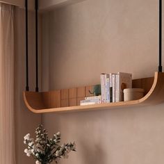 a vase filled with flowers sitting on top of a wooden shelf