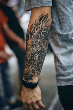 a man with a dragon tattoo on his arm holding onto another person's hand