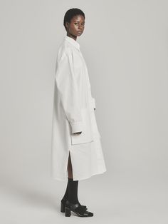 UNI FORM’s founder Luke Radloff designs timeless wardrobe staples you’ll want to wear for years to come. A shirt style that looks just as chic as a dress as it will as a light coat, this versatile number has an oversized fit with dropped shoulders, a storm flap-style overlay, and practical pockets. It’s been locally made in South Africa from pure cotton. Wear it with chunky sandals and silver jewelry. - Classic collar, concealed button fastening, long sleeves with extended cuffs, storm flap, poc Oversized White Collared Shirt Dress, Classic Oversized Shirt Dress With Spread Collar, White Fall Shirt Dress For Work, Classic White Shirt Dress For Fall, White Shirt Dress For Fall Workwear, White Shirt Dress For Workwear In Fall, Oversized Long Sleeve Shirt Dress For Office, Oversized Button-up Shirt Dress For Work, Modern Long Sleeve Shirt Dress For Work