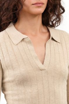 The Yak V-Neck Long Sleeve Top in Desert Sand is the ideal base layer for the winter season. Made with cozy ribbed knit fabric, this top offers a close-to-body fit for maximum warmth and a touch of elegant style with its modest v-neck and contrast ribbing on the collar. Stay comfortable and stylish all winter long. Beige Ribbed V-neck Top, Fitted V-neck Top With Ribbed Cuffs, Beige Ribbed V-neck Sweater, Beige V-neck Fine Knit Top, Beige Fine Knit V-neck Top, Fitted V-neck Sweater With Seamless Collar, Winter Beige Tops With Ribbed Neckline, Beige Ribbed Knit Top For Work, Beige Ribbed Knit Top For Workwear