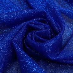 a blue fabric with small glitters is shown in close up view on the surface