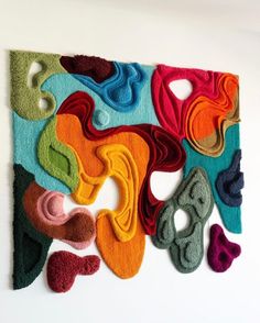 an art piece made out of felt with different colors