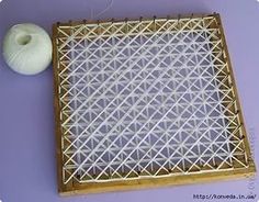 a white ball of yarn sitting on top of a wooden tray next to a piece of string