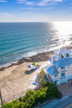 an aerial view of a house on the beach