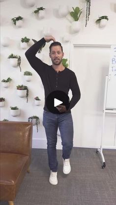 a man standing in front of a whiteboard with plants on it