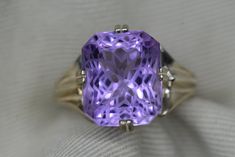 "The amethyst in this ring is set in such a way that it will touch the skin of the person wearing the ring.  Perfect for anyone wanting to wear amethyst for it's metaphysical properties.  This ring contains a genuine earth mined amethyst. The amethyst is a fabulous purple colour and has been precision cut. The precision faceting that the master cutter did when working with this amethyst has turned this gem into a piece of art. The reflection of light in this masterpiece forms a beautiful pattern that is hard to capture in pictures.   This size 6 1/2 ring is made of solid sterling silver and can be sized up or down by as much as 2 sizes for $25. This item is brand new and was appraised by a gemologist at Canadian Federal Gemological Laboratory of Canada.  The appraisal will be included with Timeless Purple Gemstone Rings, Purple Emerald-cut Ring For Formal Occasions, Purple Emerald Cut Ring For Formal Occasions, Formal Purple Emerald Cut Ring, Fine Jewelry Purple Octagon Rings, Octagon-shaped Amethyst Ring For Formal Occasions, Octagon Amethyst Ring For Formal Occasions, Octagon Amethyst Ring For Formal Events, Lavender Emerald Cut Rings For Formal Occasions