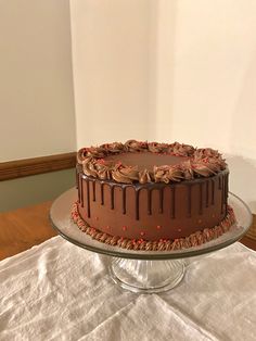 a chocolate cake sitting on top of a glass plate