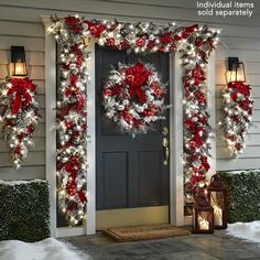 a front door decorated with christmas wreaths and lights