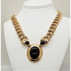 This is part of Chairish’s Costume Jewelry assortment.  Goldtone three cabochon faux-onyx rhinestones pendant necklace on a double link chain with fold over clasp. Marked "Napier." Center measures: 1 3/4 inches long by 1 7/16 inches wide.  Condition: Very good; minor goldtone wear. Most likely from Napier's 1988 Milano collection.  Please reference the measurements noted in the description above for the best approximate dimensions. Please reach out to the seller under "Ask the Seller" for specif Formal Costume Jewelry Chain Necklaces, Elegant Evening Cabochon Necklaces, Formal Oval Necklace With Black Enamel, Metal Chain Link Evening Jewelry, Evening Metal Chain Link Jewelry, Metal Chain Link Jewelry For Evening, Formal Oval Black Enamel Necklace, Oval Metal Necklace For Formal Occasions, Oval Metal Necklace For Formal Wear