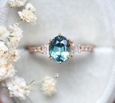 a ring with an oval blue topaz surrounded by white flowers