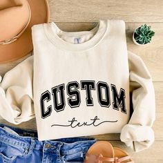 Custom Text Sweatshirt Vintage College Letters Sweatshirt Gift Retro Oversized Sweater Personalized Add Your Own Text Custom Quote Varsity Plus sizes also available: 2X, 3X, 4X, 5X -------- HOW TO ORDER -------- 1) Select your sweatshirt Size 2) Select your desired Color 3) Add personalization. 4) Click "Add to Cart" and place your order. 5) Repeat for more items. Ideal for any situation, a unisex heavy blend crewneck sweatshirt is pure comfort. These garments are made from polyester and cotton. Oversized T-shirt With Ribbed Cuffs For College, Oversized White Sweatshirt With Letter Embroidery, Oversized White Varsity Sweatshirt, White Oversized Varsity Sweatshirt, Oversized College Sweater With Letter Embroidery, Oversized Letter Embroidery Sweater For College, Oversized Crew Neck Hoodie With Lettering, Varsity Letter Print Sweater For College, Oversized College Sweatshirt With Letter Embroidery