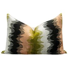 a black and white pillow with green accents on the front, sitting against a white background