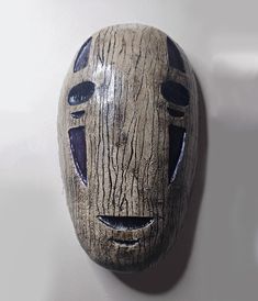 a wooden mask hanging on the wall