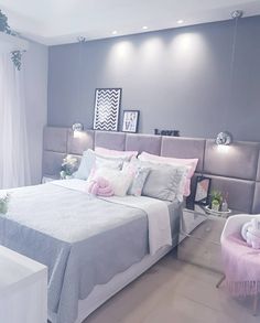 a bedroom with a bed, chair and pictures on the wall