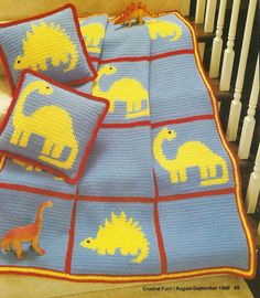 a crocheted blanket with dinosaurs on it