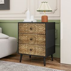 a black and gold chest of drawers in a living room next to a white couch