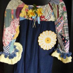 a blue dress with sunflowers on it and some fabric pieces attached to the back