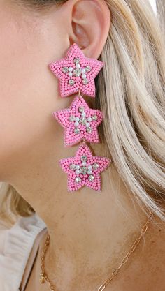 Add some sparkle and shine to your day with these cute pink beaded earrings! Featuring a star shape and tons of shimmer, dollys world earrings are sure to make you star of the show. And the best part? They won't break the bank—stellar style for a stellar price! NOT available for in store credit or exchange (see policy for more info) filter used to brighten color Pink Star Earrings For Party, Pink Star-shaped Party Earrings, Cute Pink Beaded Dangle Earrings, Cute Pink Dangle Beaded Earrings, Handmade Pink Star-shaped Jewelry, Pink Star-shaped Jewelry For Party, Pink Star Charm Jewelry, Cute Pink Jewelry With Star Charm, Star-shaped Beaded Jewelry For Party