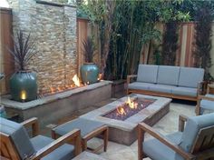 a fire pit surrounded by wooden chairs and tables