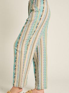 Step into summer style with these unique multicolor embroidered pants. Made in India, each pair features a trendy design and wooden button, adding a touch of quirkiness to your wardrobe. Stay cool and fashionable all season long! Color: Summer Fabric: 100% Cotton Includes: x1 Pants Sizes: XS-XL, Regular Sizing. Model is 5'8" and is wearing S. Embroidered Wide Leg Harem Pants For Spring, Casual Embroidered Harem Pants For Spring, Casual Spring Embroidered Harem Pants, Bohemian Cotton Bottoms For Day Out, Bohemian High-waisted Bottoms For Loungewear, Bohemian High-waisted Pants For Loungewear, Green Bohemian High-waisted Pants, Bohemian High-waisted Lounge Pants, Multicolor Cotton Bottoms For Day Out