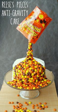 a cake covered in candy and sprinkles on top of a glass plate