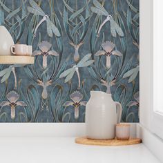 the wallpaper in this kitchen is designed with blue flowers and birds