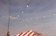 an umbrella and some string lights in the sky