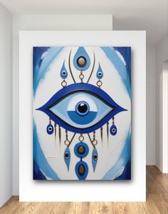 an eye is shown on the wall above a painting in a room with wood floors