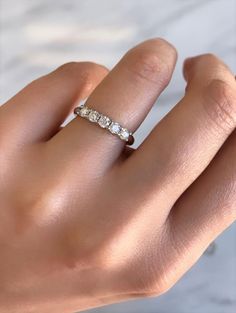 a woman's hand with a diamond ring on it