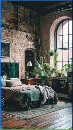 a bedroom with brick walls and green bedding in front of an arched window on the wall