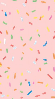 colorful sprinkles on a pink background