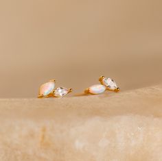 If elegance is your goal, look no further than our Opal & Diamond Marquise Studs. With their mismatched design and delicate nature, these earrings add a touch of uniqueness while still remaining classic. Give as a meaningful gift to your bridesmaids so they may all remember the special day. Material: High Quality Solid 925 Sterling Silver Finish: 18K Gold ∙ Sterling Silver Featuring ~5x2mm Marquise Opal & Diamond Gemstones Sold as a pair Part of our Opal Collection Model showcases a understated, Initial Tag Necklace, Sideways Initial Necklace, Dainty Initial Necklace, Opal Earrings Stud, Opal Studs, Birthstone Gifts, Station Necklace, Opal Earrings, Delicate Earrings