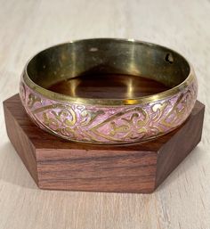 "High-quality brass vintage brass bracelet, perfect for summer festival wear.  This bracelet features a lovely inlaid pink floral/heart design. Embrace your bohemian spirit with this bold and chunky cuff.   This bracelet will comfortably fit a 6 3/4\" to 7 1/4\" wrist The width of the bracelet at the widest point is 3/4\" The inside circumference measures 8\" Condition: Great vintage condition, moderate signs of wear" Traditional Pink Bangle As Gift, Traditional Pink Bangle For Gift, Bohemian Antique Gold Bracelets For Gift, Bohemian Pink Cuff Bracelet As Gift, Adjustable Pink Bohemian Cuff Bracelet, Bohemian Adjustable Pink Cuff Bracelet, Pink Bohemian Adjustable Cuff Bracelet, Festival Bracelets With Engraving, Vintage Bracelets For Festivals