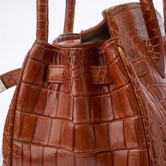 Extraordinary, exclusive creations, meticulously handcrafted by an Austrian-born master craftsman in South Africa. Made from genuine crocodile skin sourced through Hermes Cuir Précieux, the epitome of elegance and prestige Original Retail Price: $12,000 Large Hermes Birkin 35-style bag. Pre-owned Cognac Color Genuine Nile Crocodile Skin ( Hermes cuir precieux) Tote with side straps and turn-lock hanging key fob croc skin-wrapped padlock with a set of keys two rounded top handles internal zip poc Classic Brown Crocodile Pattern Shoulder Bag, Classic Brown Bag With Crocodile Pattern, Luxury Brown Crocodile Pattern Bag, Elegant Brown Bag With Crocodile Pattern, Elegant Brown Crocodile Pattern Bag, Luxury Brown Shoulder Bag With Crocodile Pattern, Luxury Brown Crocodile Pattern Shoulder Bag, Designer Brown Crocodile Pattern Shoulder Bag, Designer Brown Shoulder Bag With Crocodile Pattern